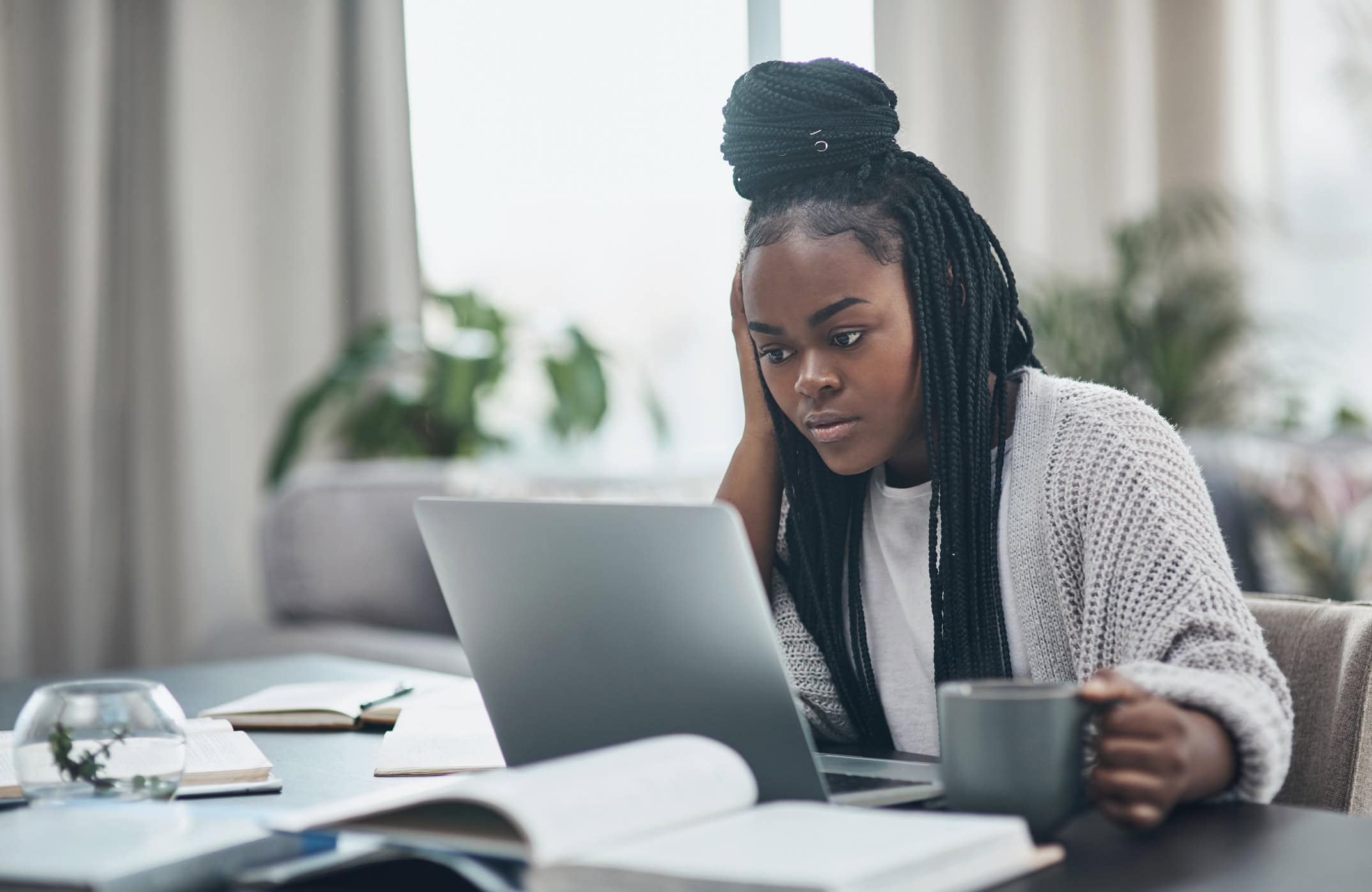 Shot of a young woman using a laptop at home