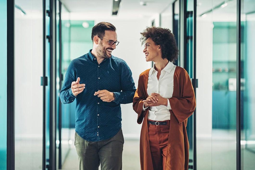 Colleagues walking together and talking