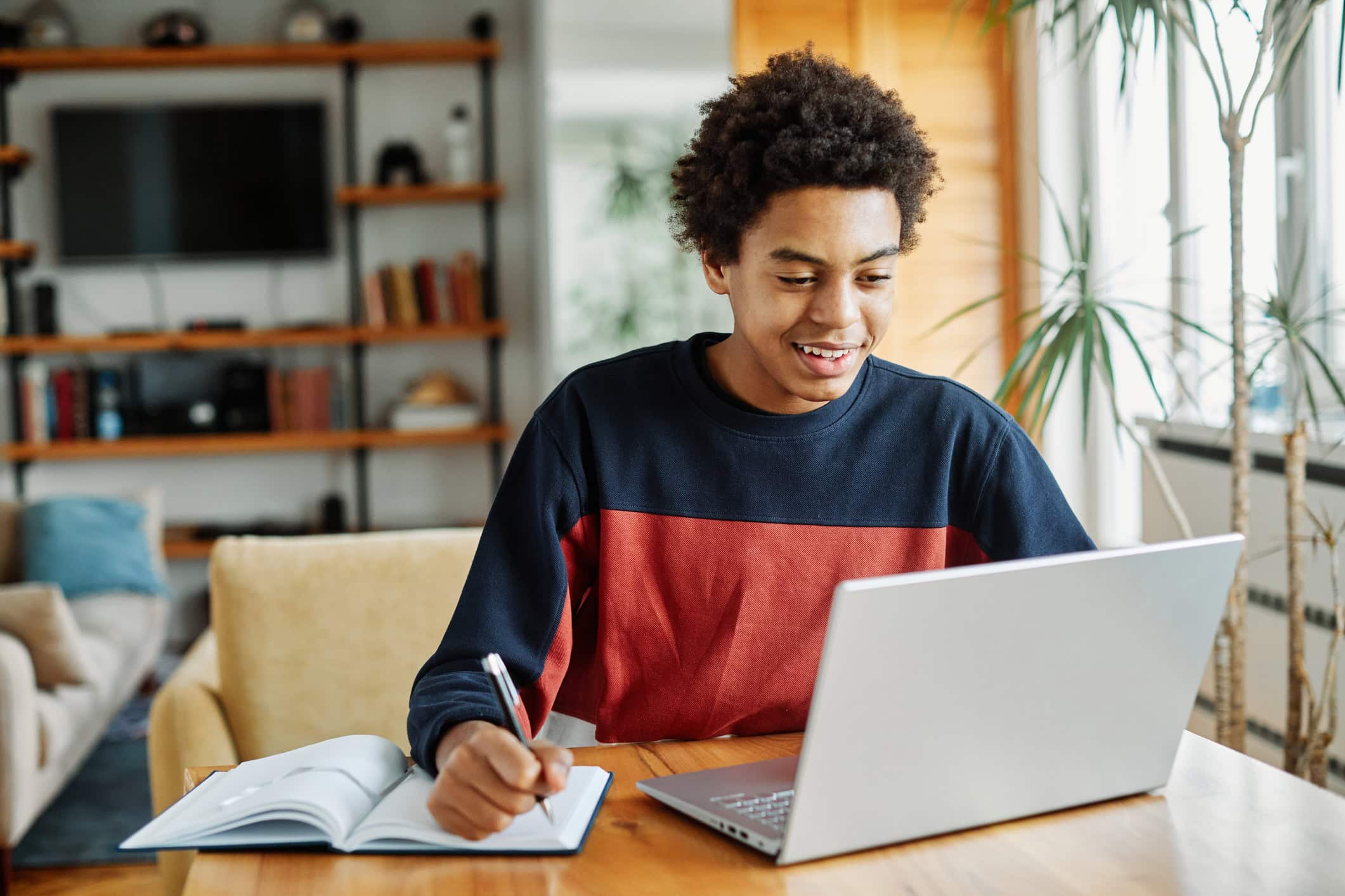 Teen student using laptop computer