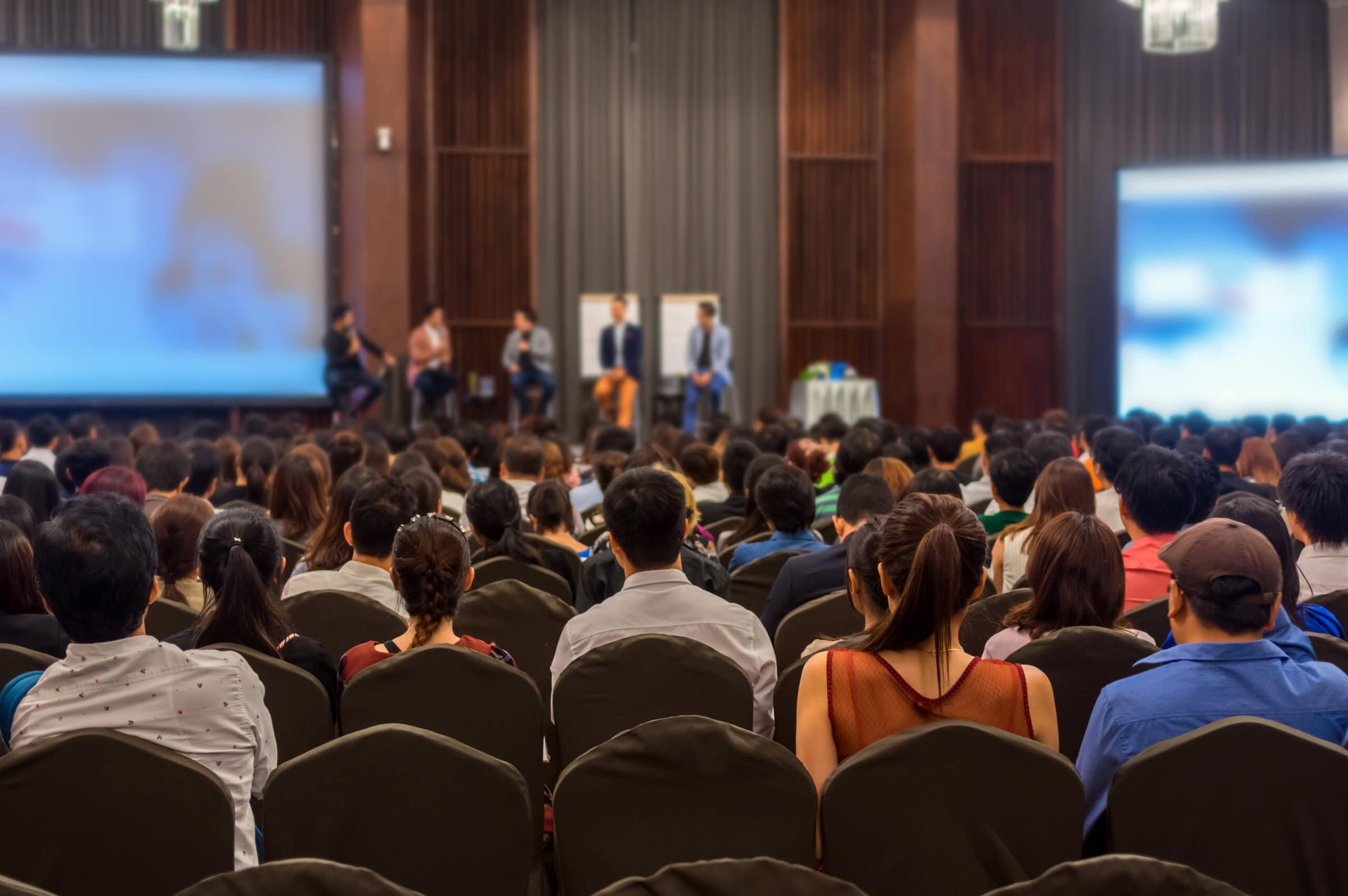 Abstract,Blurred,Photo,Of,Conference,Hall,Or,Seminar,Room,With