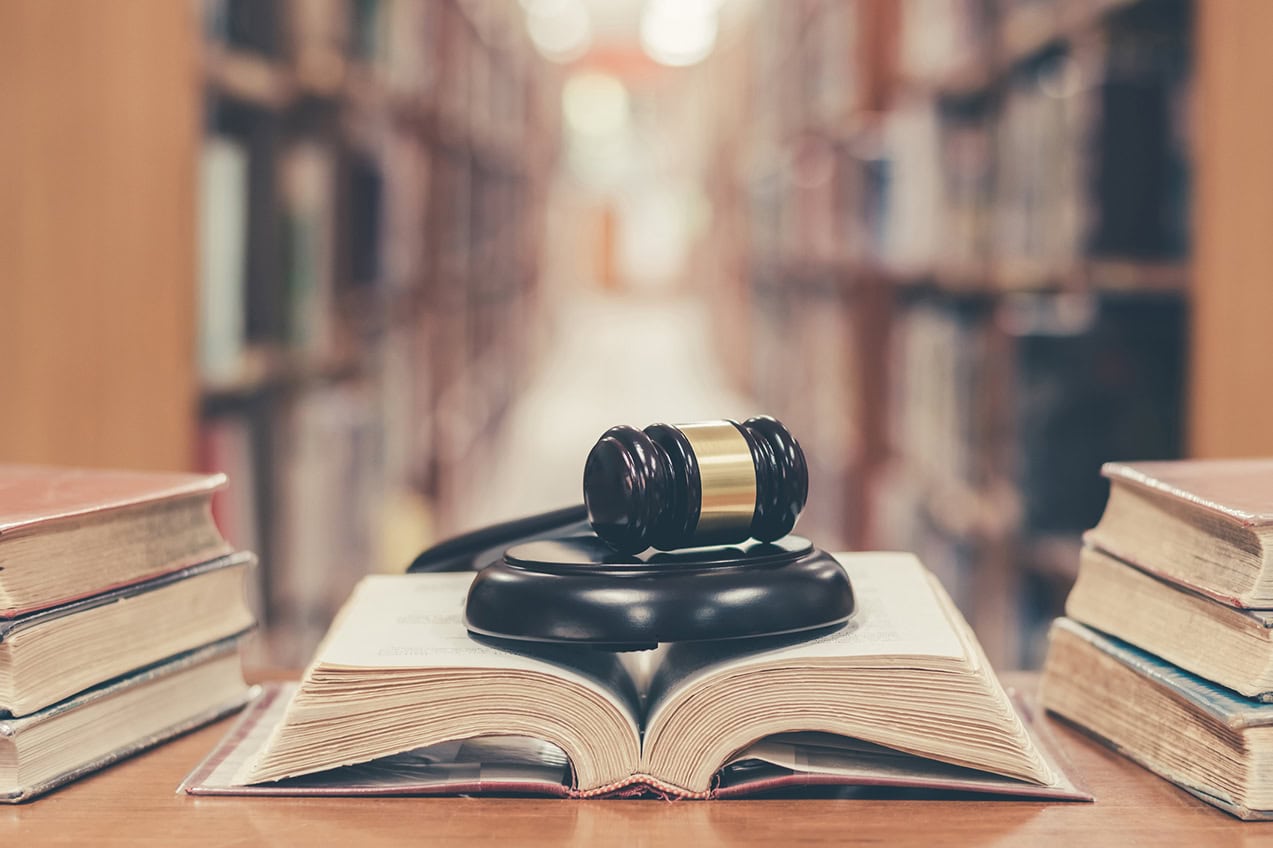 Gavel on open book in library