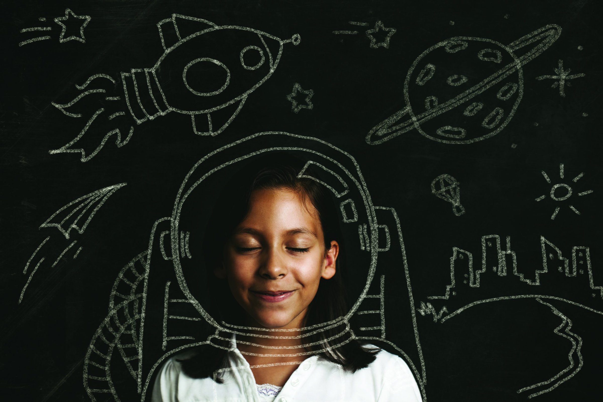 Young girl with eyes closed using imagination