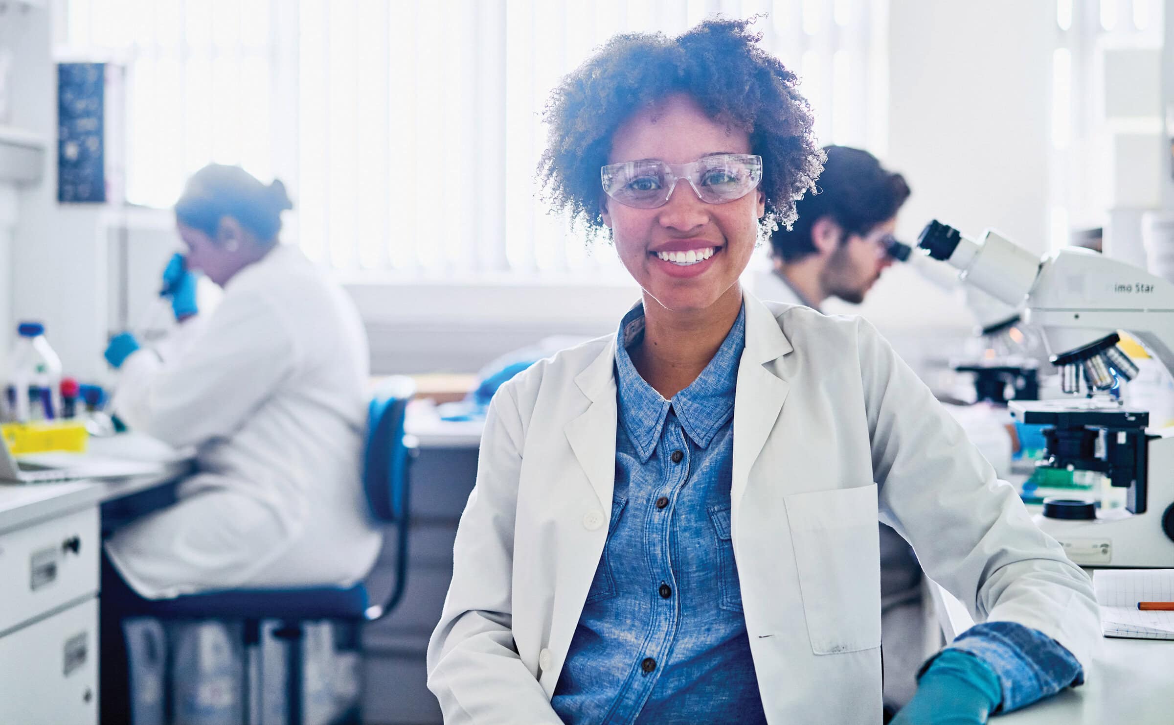 Young woman in lab coat working in lab