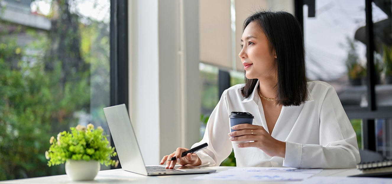 Woman looking out window thinking