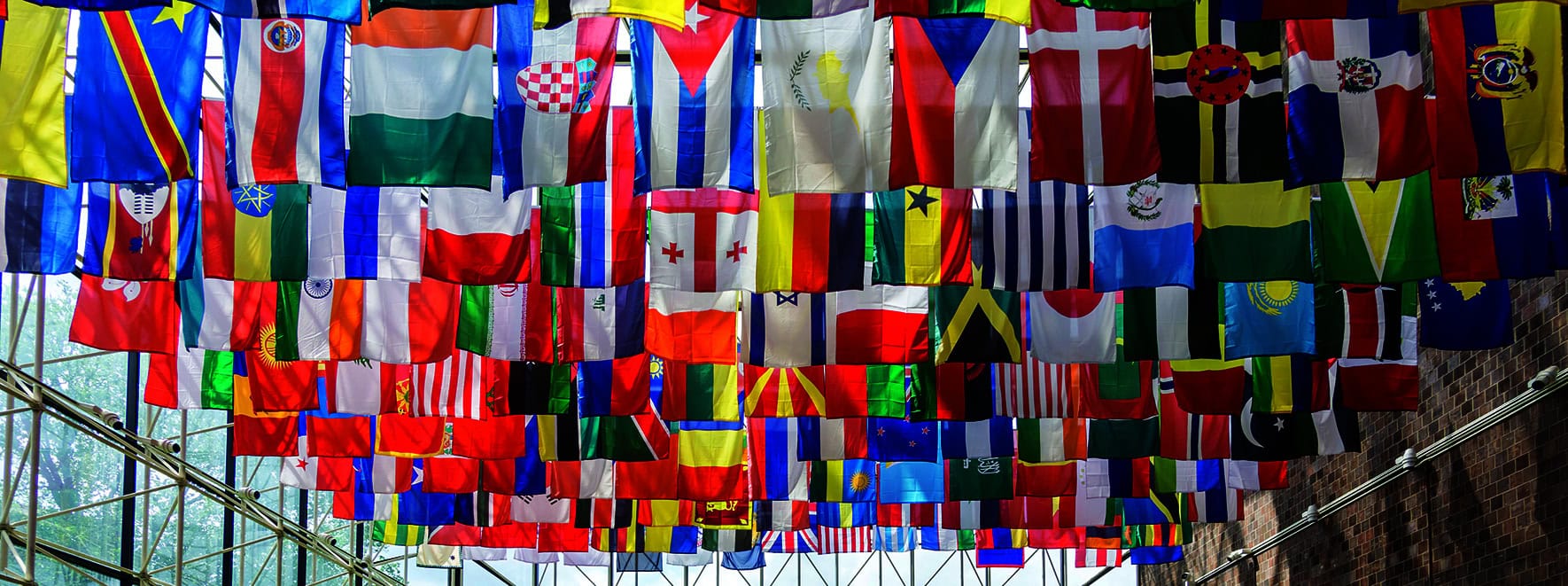 Flags of many countries are shown hanging from ceiling