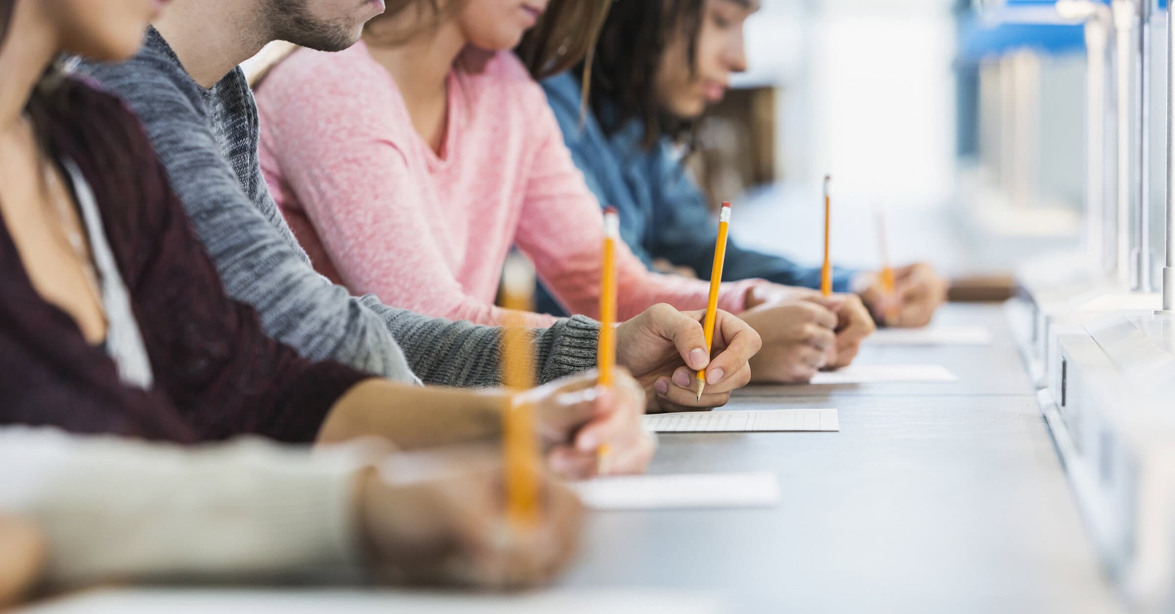 Students taking written test in classroom