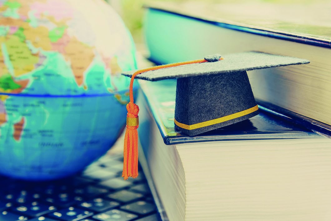 Globe and graduation cap are shown to give idea of international/global education