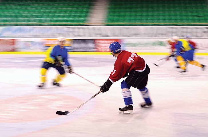 Ice hockey play - front player in focus
