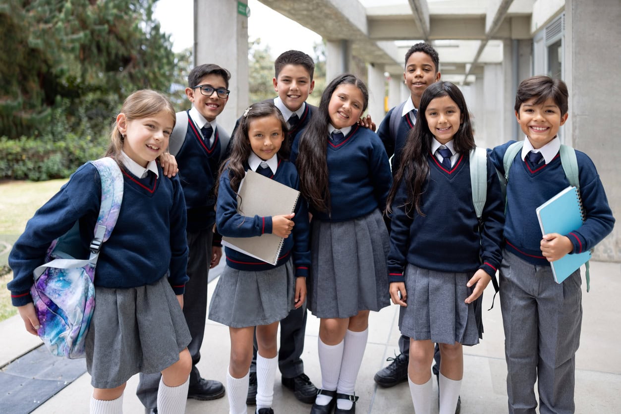 Portrait of happy elementary students smiling at the school