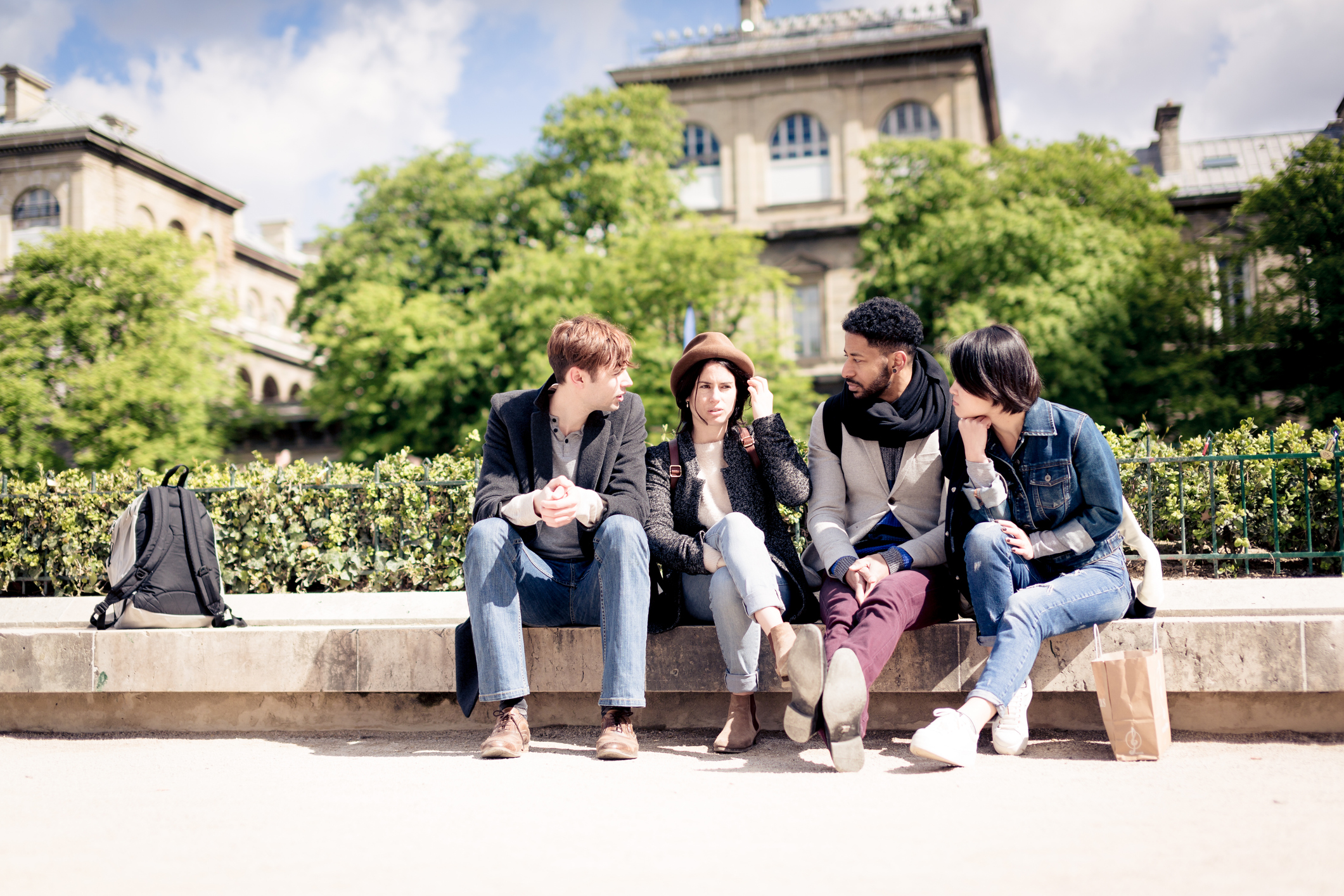 Multi-ethnic group of friends having fun in Paris, near Notre Dame Cathedral.