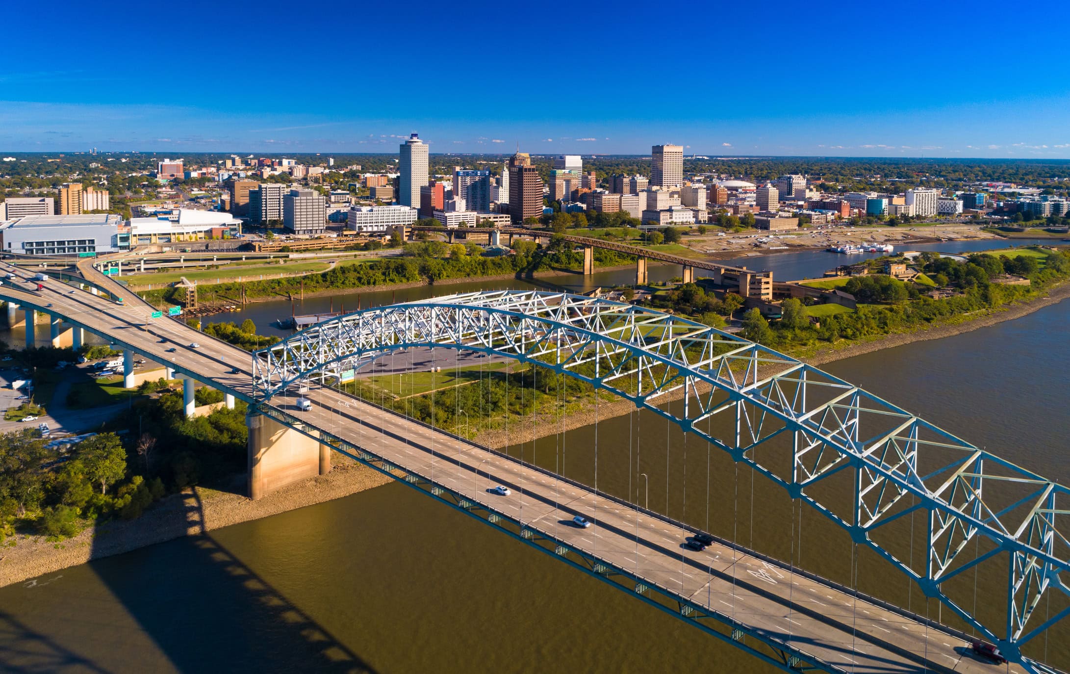 Downtown Memphis skyline aerial view with the Hernando De Soto bridge and the Mississippi River and Mud Island in the foreground.