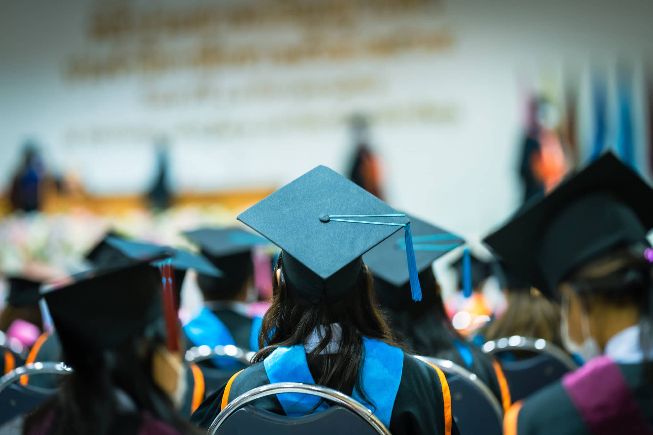 University graduates during commencement, shown from behind