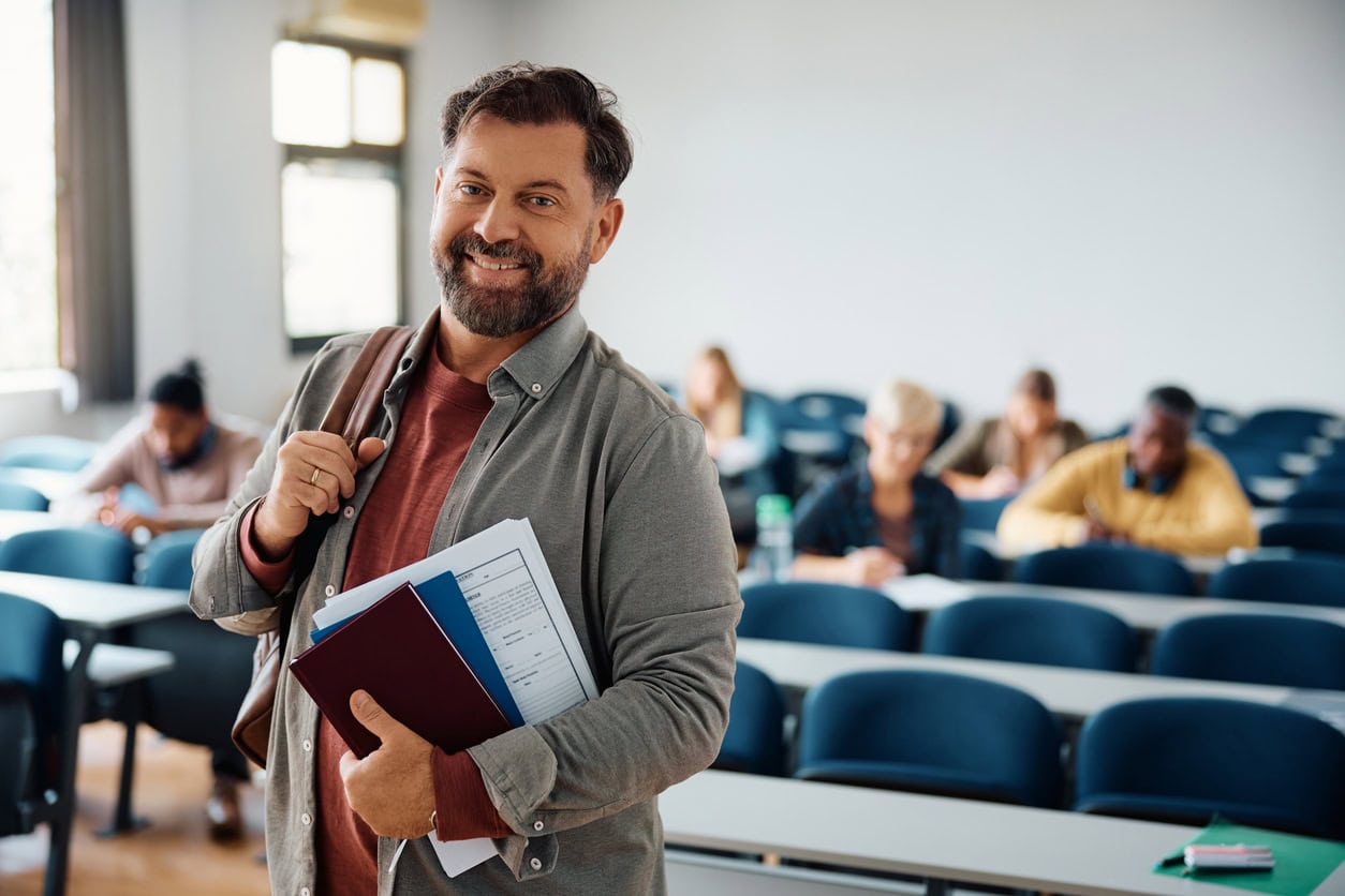 Happy mature man attending class and looking at camera.