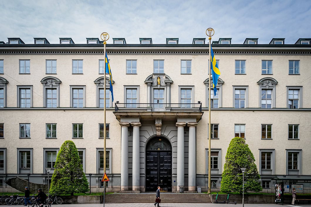 Stockholm , Sweden - May 25, 2021: Horizontal front view of the famous Stockholm School of Economics building, Handelshögskolan with incidental people in Stockholm Sweden May 25, 2021.