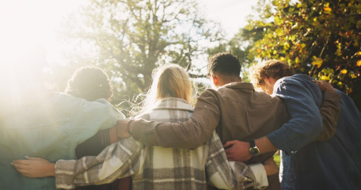 Group of friends shown from behind in nature