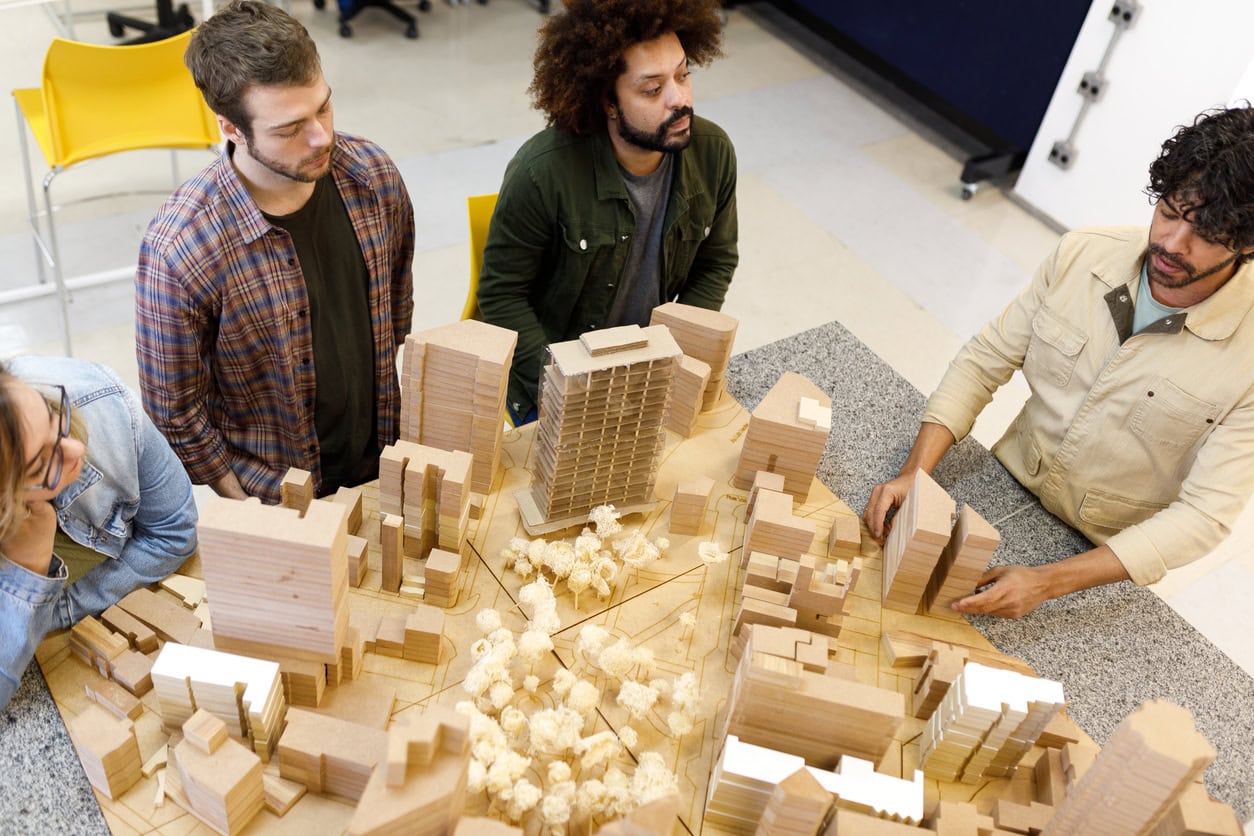 Professor talking to students about architecture models