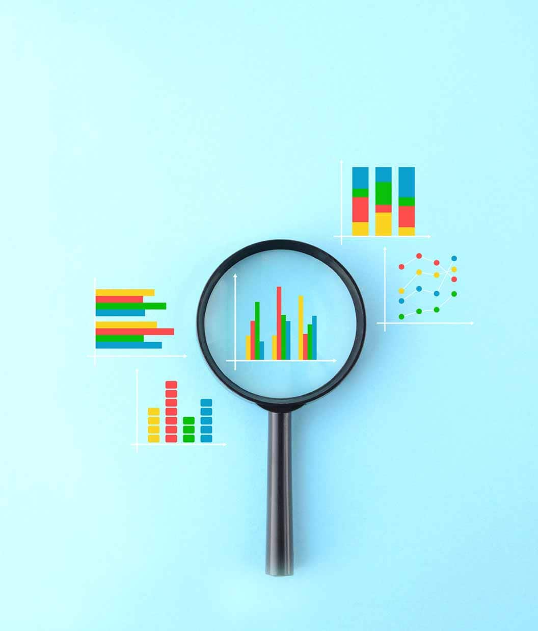 Magnifying glass and various business graphs on light blue background