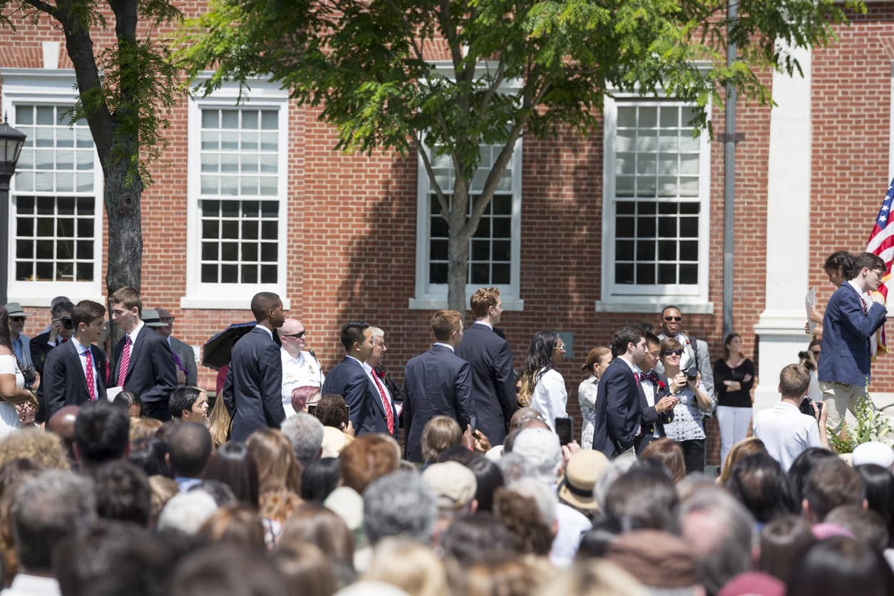 Exeter, New Hampshire, USA - June 7, 2015: Young men and women are lined up in front of the stage, in anticipation of accepting their diplomas. Phillips Exeter Academy, a world-renowned college preparatory school frequently rated one of the best in the nation, celebrates graduation of its seniors during a warm summer day.